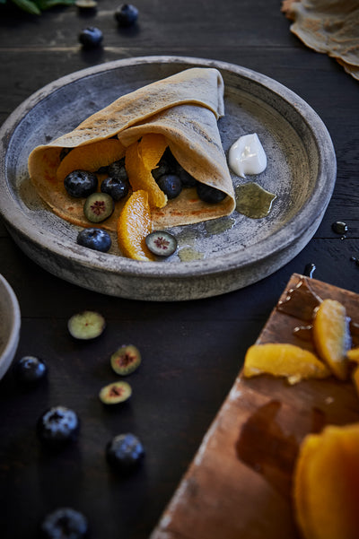 Buckwheat Crepes with coconut yoghurt, blue berries, orange and mint